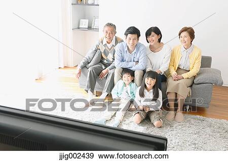 Stock Photo - Three-generation Japanese family on the sofa in the living room. Fotosearch