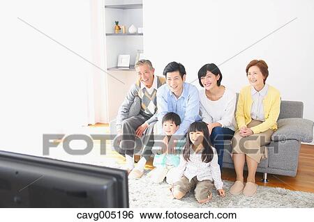Stock Photograph - Three-generation Japanese family on the sofa in the living room. Fotosearch