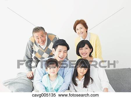 Stock Photography - Three-generation Japanese family on the sofa in the living room. Fotosearch