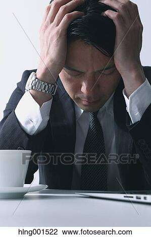 Stock Image - Tired Japanese businessman. Fotosearch