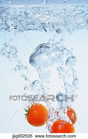 Stock Photography - Tomatoes in water. Fotosearch