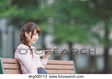Stock Image - University student in the campus park. Fotosearch