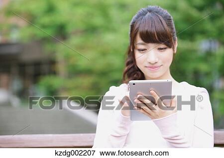 Stock Photo - University student in the campus park. Fotosearch