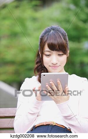 Stock Photo - University student in the campus park. Fotosearch