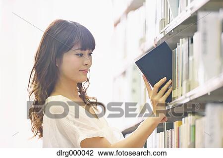 University student in the library View Large Photo Image Stock Image - University student in the library. Fotosearch