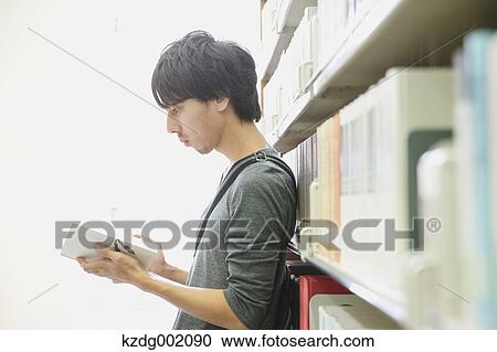 University student in the library View Large Photo Image Stock Image - University student in the library. Fotosearch