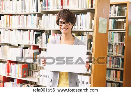 University student in the library View Large Photo Image Stock Photograph - University student in the library. Fotosearch