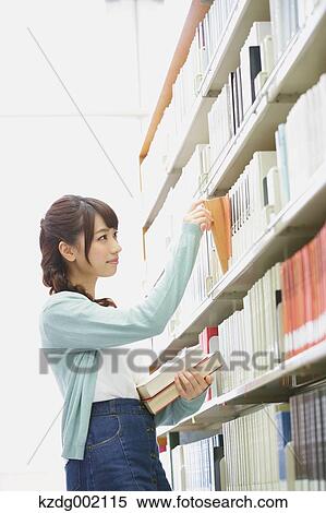 Stock Photography - University student in the library. Fotosearch