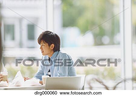 Stock Image - University student in the school cafe. Fotosearch