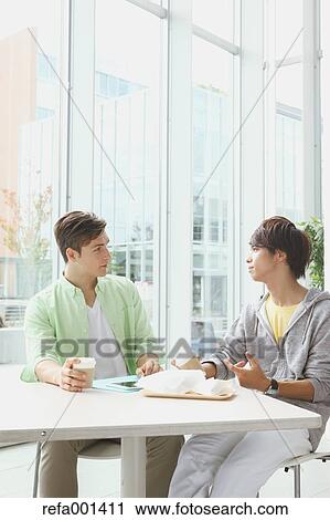 Stock Image - University student in the school cafe. Fotosearch