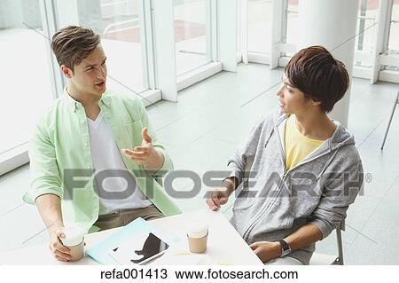 Stock Image - University student in the school cafe. Fotosearch