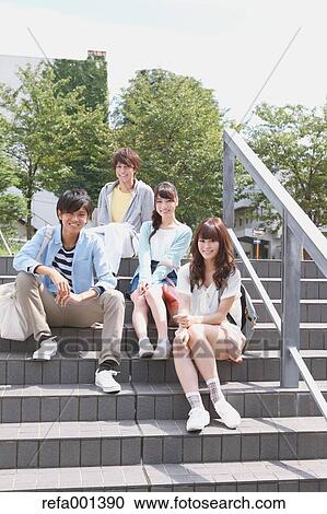 Stock Image - University students in the campus park. Fotosearch