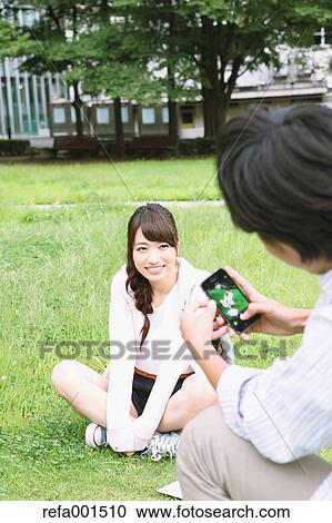 Stock Image - University students in the campus park. Fotosearch