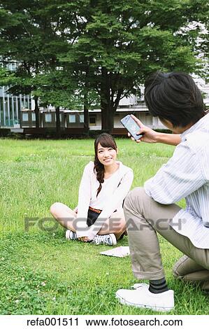 Stock Image - University students in the campus park. Fotosearch