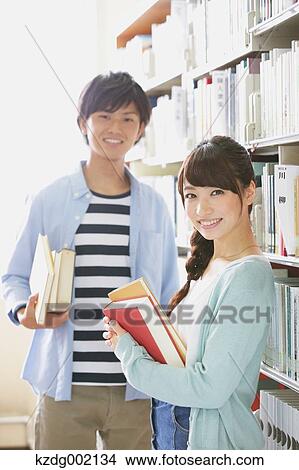 Picture - University students in the library. Fotosearch