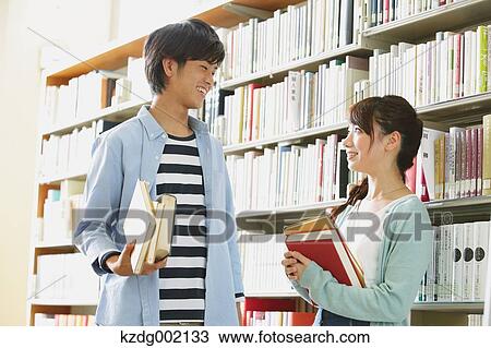 Stock Image - University students in the library. Fotosearch