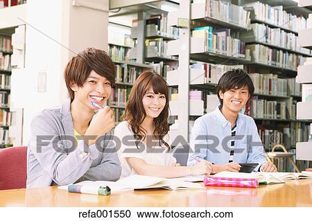 Stock Image - University students in the library. Fotosearch