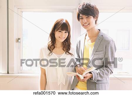 Stock Image - University students in the library. Fotosearch