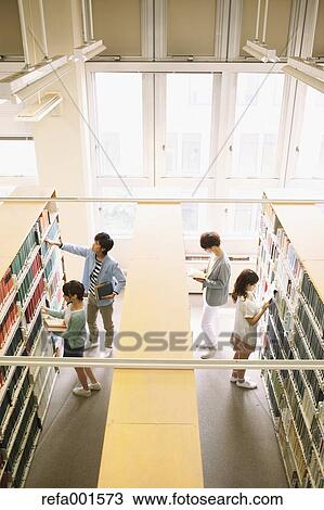 Stock Image - University students in the library. Fotosearch
