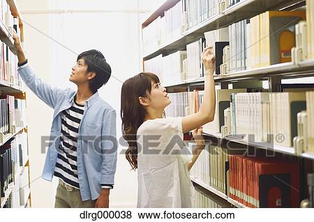 Stock Photo - University students in the library. Fotosearch