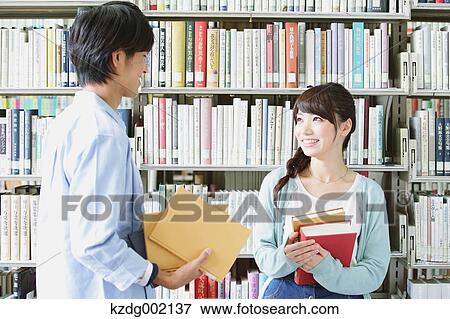 Stock Photo - University students in the library. Fotosearch