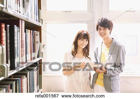 Stock Photo - University students in the library. Fotosearch
