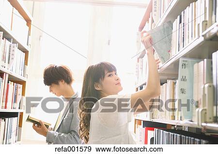 Stock Photo - University students in the library. Fotosearch