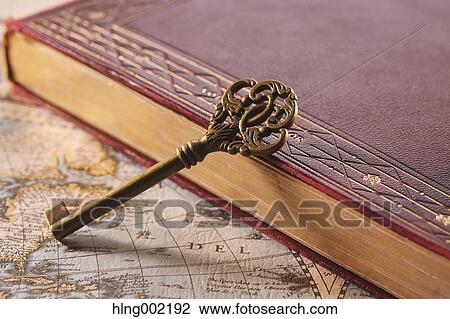 Stock Image - Vintage key and book. Fotosearch