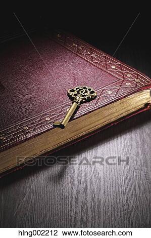 Stock Image - Vintage key and book. Fotosearch
