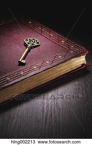Stock Image - Vintage key and book. Fotosearch