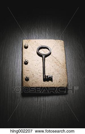 Vintage key and book View Large Photo Image Stock Photo - Vintage key and book. Fotosearch