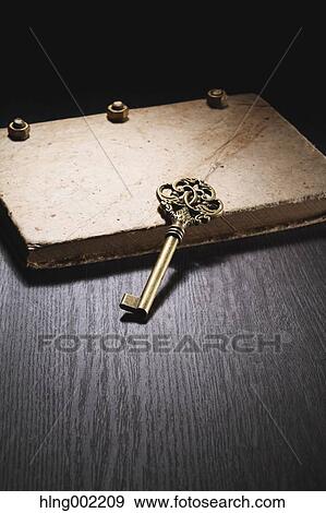 Vintage key and book View Large Photo Image Stock Photo - Vintage key and book. Fotosearch
