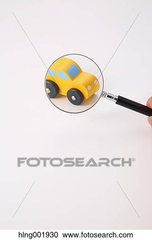 Wooden toy car and magnifying glass View Large Photo Image Stock Image - Wooden toy car and magnifying glass. Fotosearch