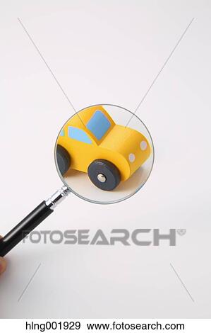 Wooden toy car and magnifying glass View Large Photo Image Stock Photo - Wooden toy car and magnifying glass. Fotosearch