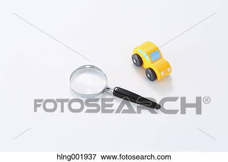 Wooden toy car and magnifying glass View Large Photo Image Stock Photo - Wooden toy car and magnifying glass. Fotosearch