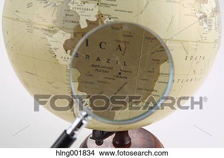 World globe and magnifying glass View Large Photo Image Picture - World globe and magnifying glass. Fotosearch
