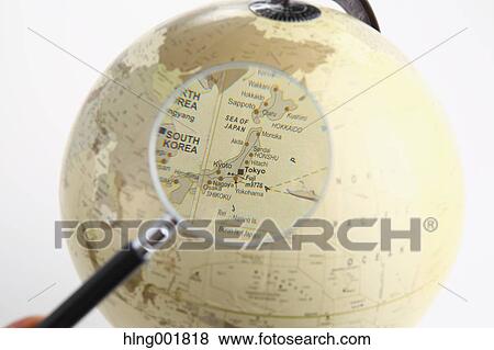 Stock Photo - World globe and magnifying glass. Fotosearch