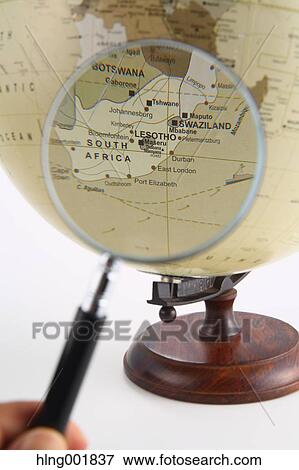 Stock Photo - World globe and magnifying glass. Fotosearch