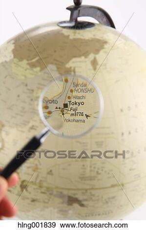 Stock Photo - World globe and magnifying glass. Fotosearch