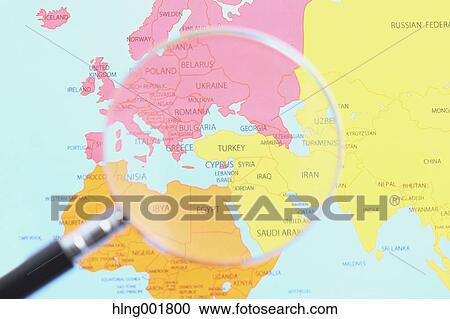 Stock Image - World map and magnifying glass. Fotosearch