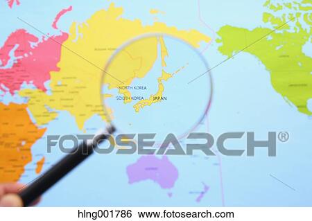 Stock Photograph - World map and magnifying glass. Fotosearch