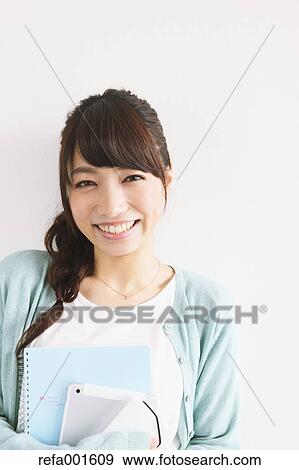Stock Photo - Young attractive Japanese female University student portrait. Fotosearch
