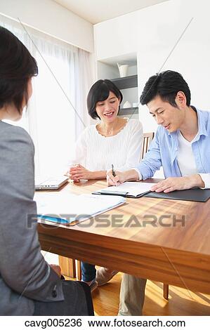 Young Japanese couple consulting with financial planner View Large Photo Image Stock Photograph - Young Japanese couple consulting with financial planner. Fotosearch