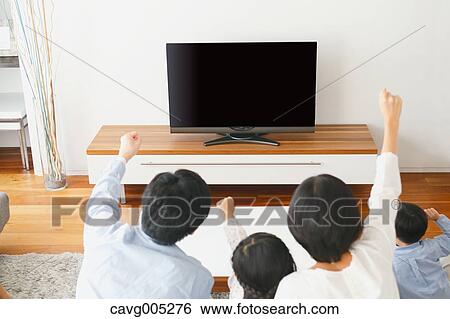Young Japanese family watching TV in the living room View Large Photo Image Stock Photograph - Young Japanese family watching TV in the living room. Fotosearch