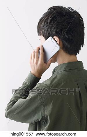 Stock Photo - Young Japanese man on the phone. Fotosearch