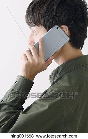 Young Japanese man on the phone View Large Photo Image Stock Photo - Young Japanese man on the phone. Fotosearch