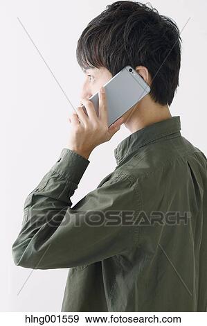 Young Japanese man on the phone View Large Photo Image Stock Photo - Young Japanese man on the phone. Fotosearch