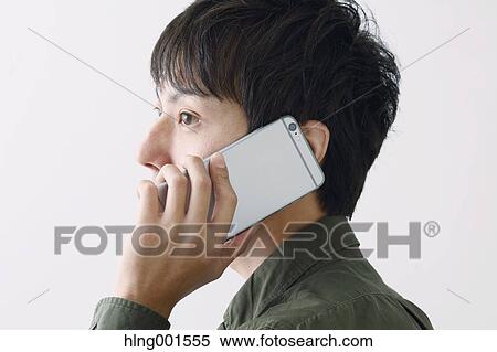 Stock Photography - Young Japanese man on the phone. Fotosearch