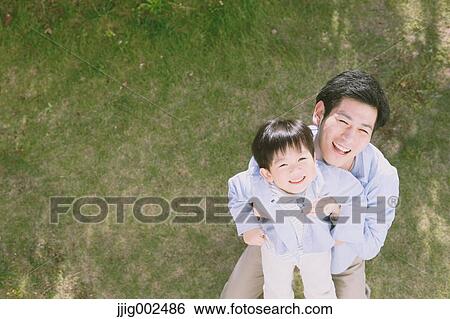 Young Japanese man playing with his son View Large Photo Image Stock Photograph - Young Japanese man playing with his son. Fotosearch