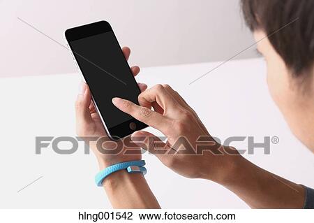 Young Japanese man using smartphone View Large Photo Image Stock Image - Young Japanese man using smartphone. Fotosearch